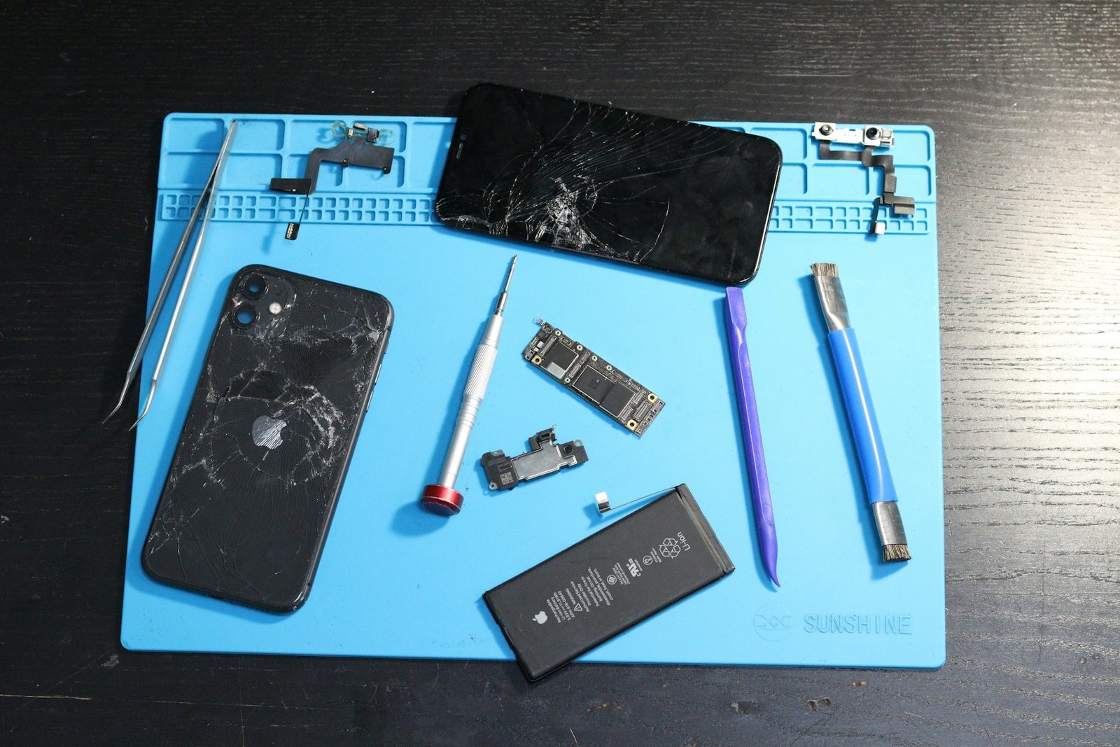 Smartphone opened on a workbench for repair